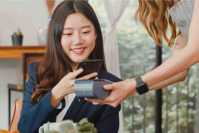 Young Asian business women pay contactless