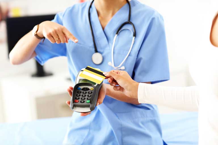 Patient paying a doctor through a contactless payment terminal