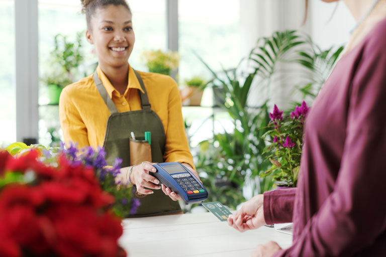 Customer paying with a credit card at a flower shop